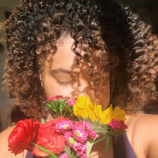 woman sniffing flowers